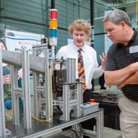 A student explaining his project to guests at the Engineering Design Project Preview